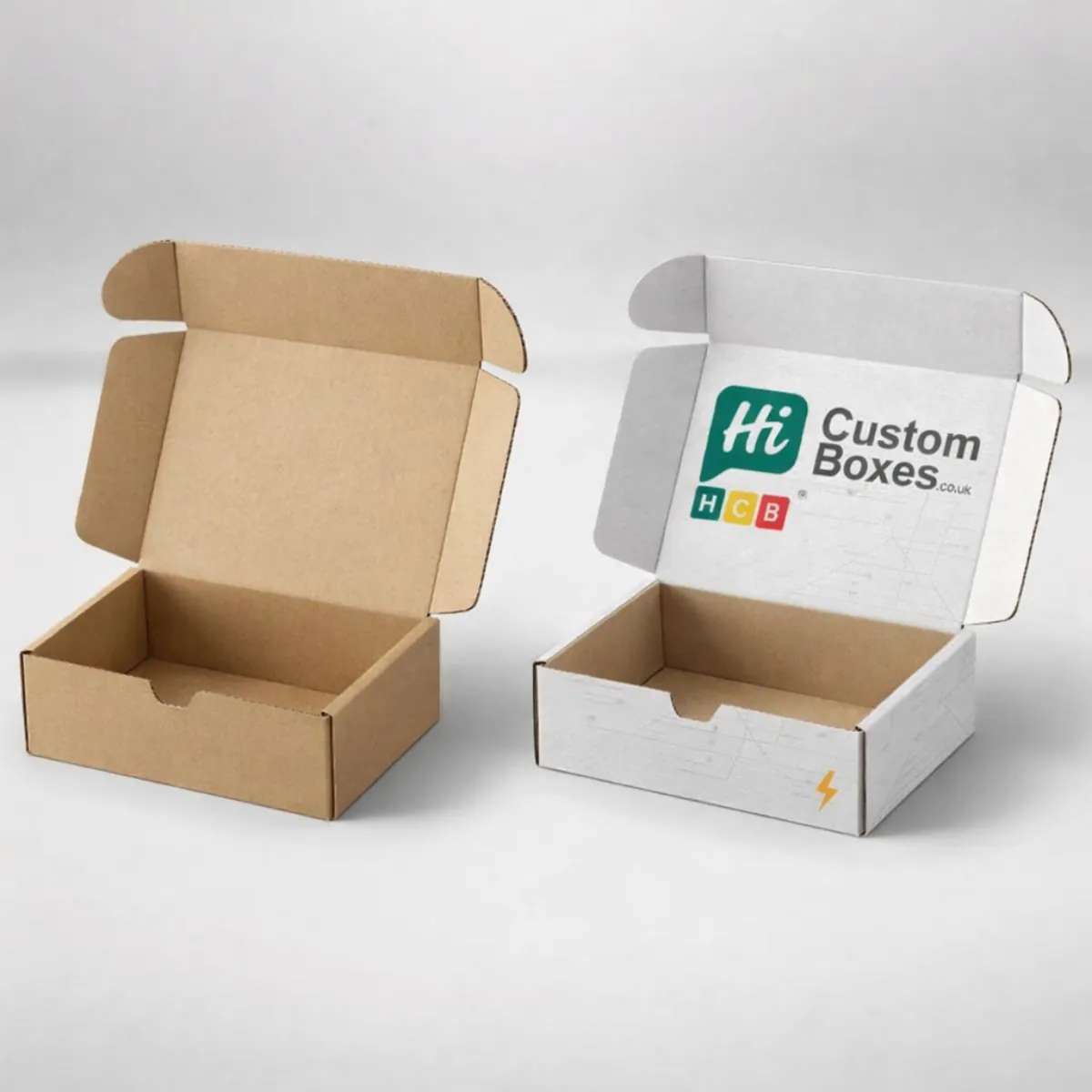 Two small corrugated cardboard mailer boxes, one plain brown and one white with a logo. class=